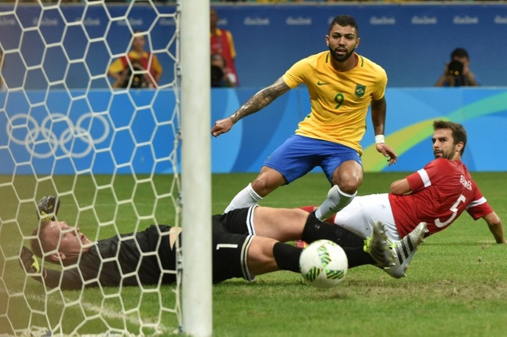 Gabriel (C) of Brazil kicks the ball to score against Denmark during the Rio 2016 Olympic Games Group A football match