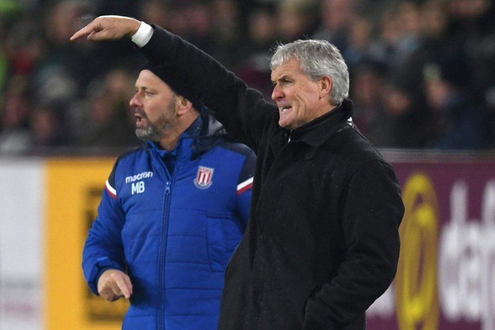 Hughes: FA Cup misery could be a blessing. AFP