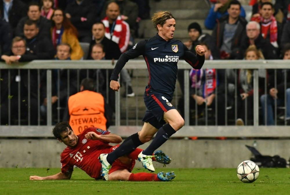 Atletico Madrids forward Fernando Torres is fouled by Bayern Munichs midfielder Javier Martinez for a penalty during the UEFA Champions League semi-final, second-leg football match between in Munich, Germany, on May 3, 2016