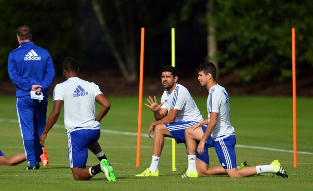 Chelseas Spanish striker Diego Costa (2R) stretches during a training session at Chelseas training ground in Stoke DAbernon, on July 31, 2015