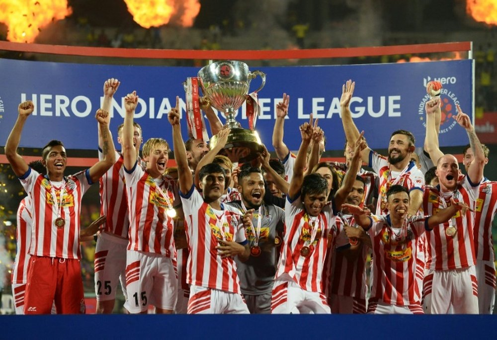 Atletico de Kolkata players celebrate with the trophy. AFP