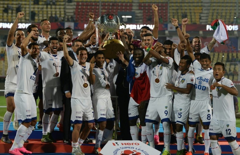 Chennaiyin FC players pose with the trophy as they celebrate after winning the final match against FC Goa during the Indian Super League football tournament on December 20, 2015