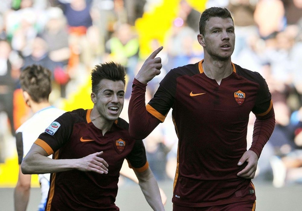 AS Romaâs forward Edin Dzeko (R) celebrates after scoring a goal during the Italian Serie A football match between Udinese Calcio and AS Roma on March 13, 2016, at the Dacia Arena in Udine