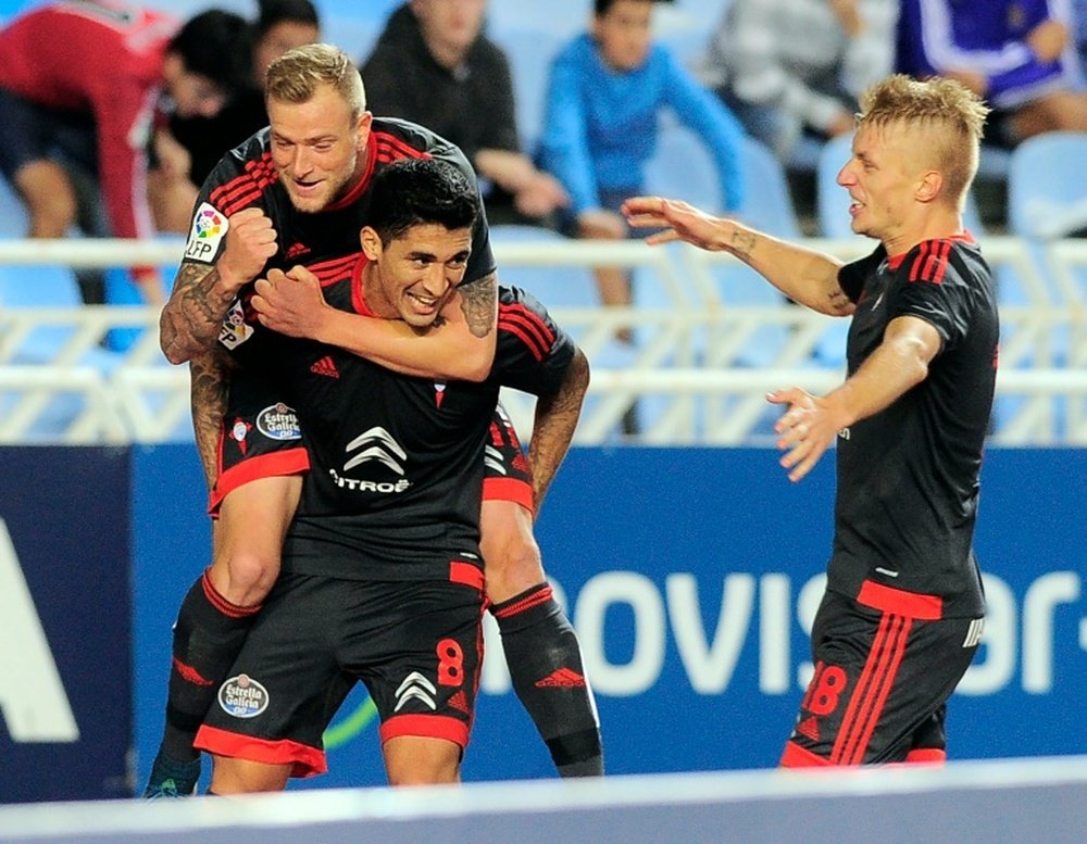 Celta Vigos midfielder Pablo Hernandez (C) celebrates a goal with teammates John Guidetti (L) and Daniel Wass (R) during the Spanish league football match Real Sociedad vs Celta Vigo in San Sebastian on October 31, 2015