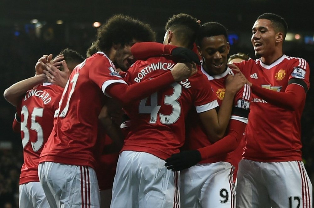 Manchester United players celebrate the opening goal scored by teammate Jesse Lingard during the Premier League match against Stoke City at Old Trafford on February 2, 2016