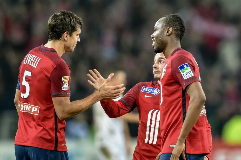 Lilles players celebrate at the end of the French League Cup football match between Lille and Laval on December 15, 2015 at the Pierre Mauroy stadium in Villeneuve dAscq, northern france