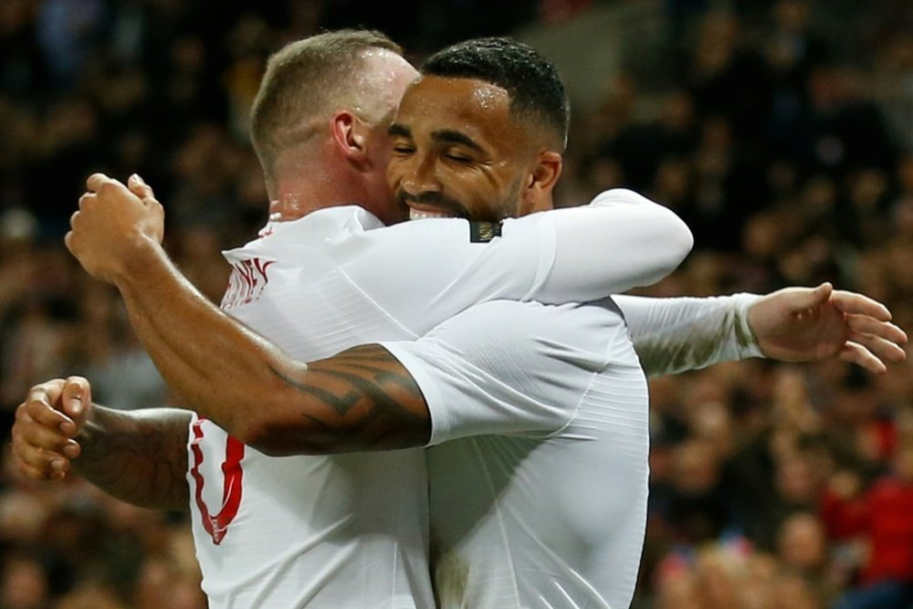 Wilson celebrates with Rooney after scoring against the USA. AFP