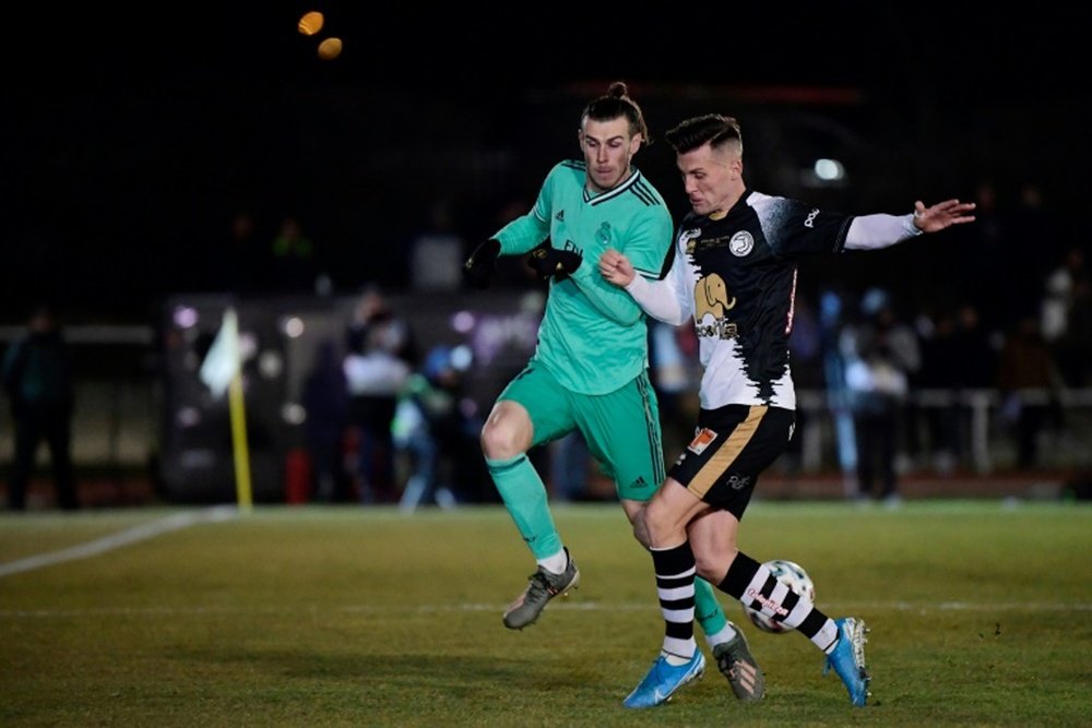 Bale came off holding his ankle. AFP