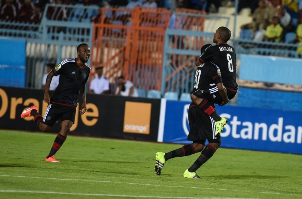 Pirates players celebrate a goal during the second leg of the semi final of the 2015 CAF - Confederation of African Football Cup - between Egyptian team Al Ahly and South African team Orlando Pirates on October 4, 2015 at Suez Stadium