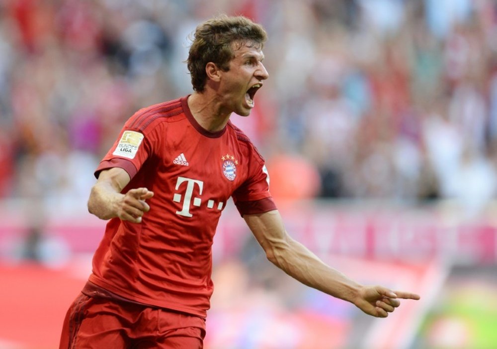 Bayern Munichs striker Thomas Mueller celebrates after scoring the first goal for Munich during the German first division Bundesliga match against Bayer 04 Leverkusen in Munich on August 29, 2015RESTRICTIONS: DURING MATCH TIME: DFL RULES TO LIMIT THE ONLINE USAGE TO 15 PICTURES PER MATCH AND FORBID IMAGE SEQUENCES TO SIMULATE VIDEO. == RESTRICTED TO EDITORIAL USE ==FOR FURTHER QUERIES PLEASE CONTACT DFL DIRECTLY AT + 49 69 650050.