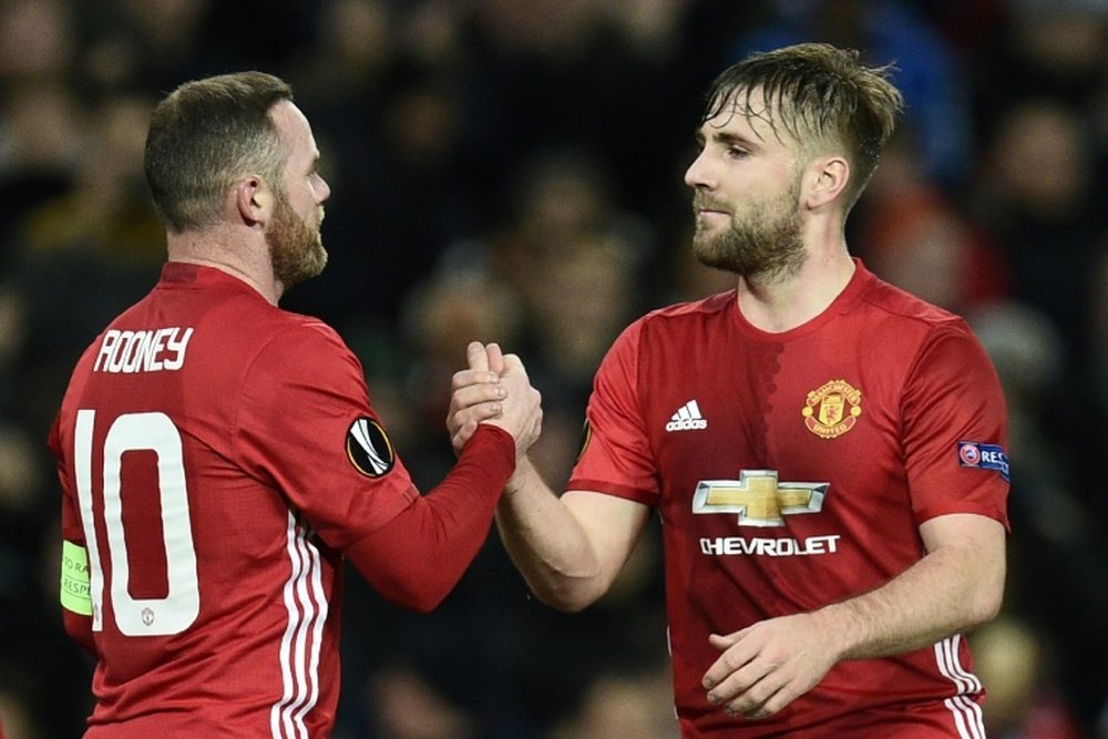 Manchester United's striker Wayne Rooney (L) celebrates scoring the opening goal with Manchester United's defender Luke Shaw during the UEFA Europa League football match against Feyenoord November 24, 2016