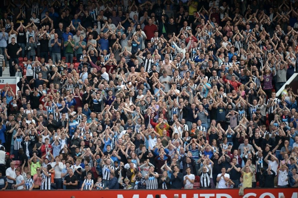 Newcastle United supporters celebrate after an English Premier League football match in Manchester, on August 22, 2015