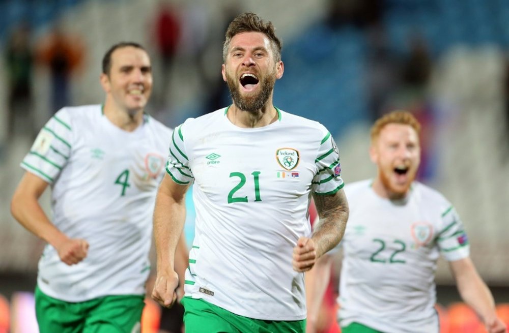 Irelands Daryl Murphy (C) celebrates scoring with teammates John OShea (L) and Stephen Quinn on September 5, 2016