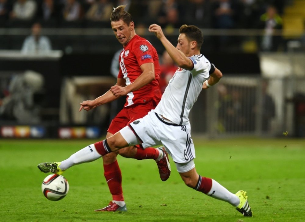 Polands Grzegorz Krychowiak and Germanys midfielder Mesut Ozil vie for the ball during their Euro 2016 qualifying match in Frankfurt am Main, Germany, on September 4, 2015