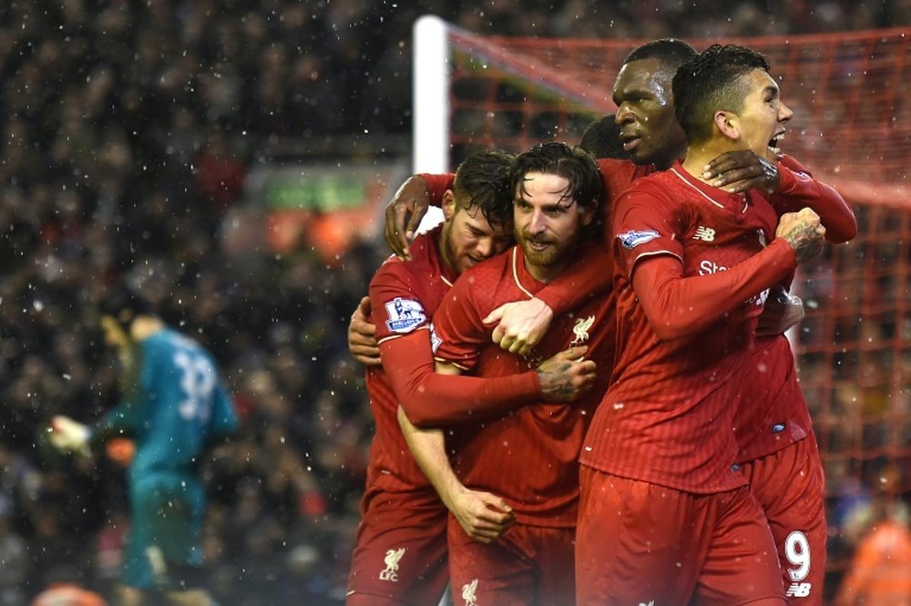 Liverpools midfielder Joe Allen (C) celebrates with teammates after scoring during the match against Arsenal at Anfield stadium in Liverpool on January 13, 2016