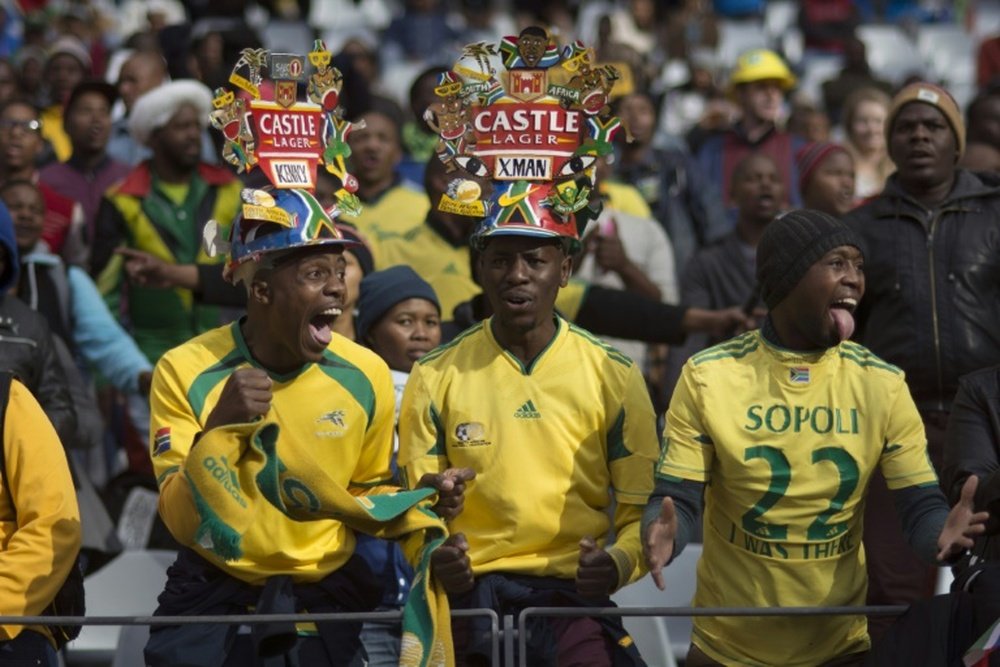 Fans of South Africas football team, Bafana Bafana cheer for their team on June 16, 2015, in Cape Town