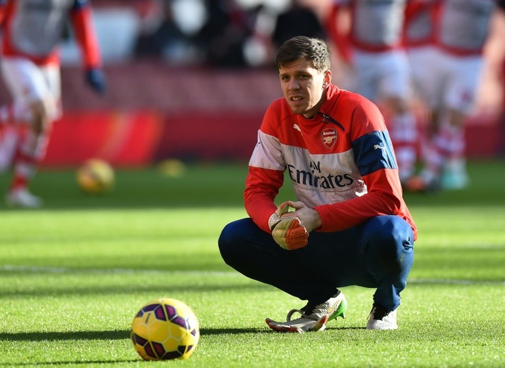 Goalkeeper Wojciech Szczesny takes a break during warm up ahead of the English Premier League football match between Arsenal and Stoke City at the Emirates Stadium in London on January 11, 2015