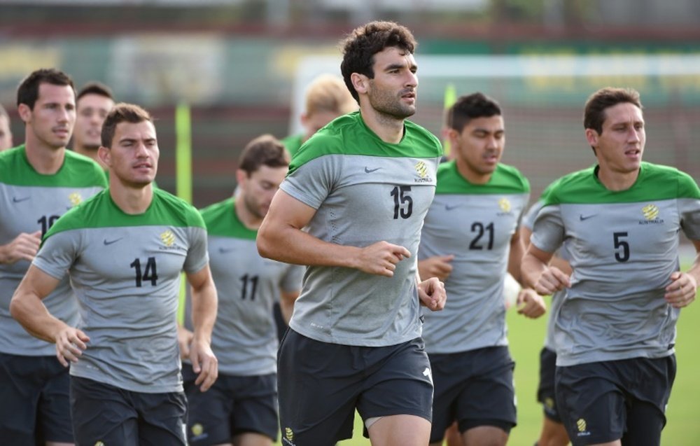 Australian Socceroos captain Mile Jedinak (centre) jogs with teammates during a training run in Vitoria on June 11, 2014