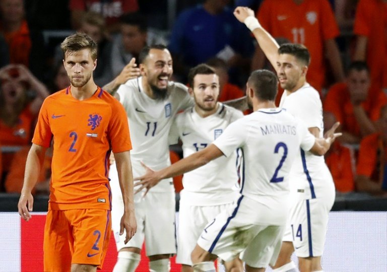 Greeces players (R) celebrate after winning a friendly football match against Netherlands at the Philips Stadium in Eindhoven, on September 1, 2016