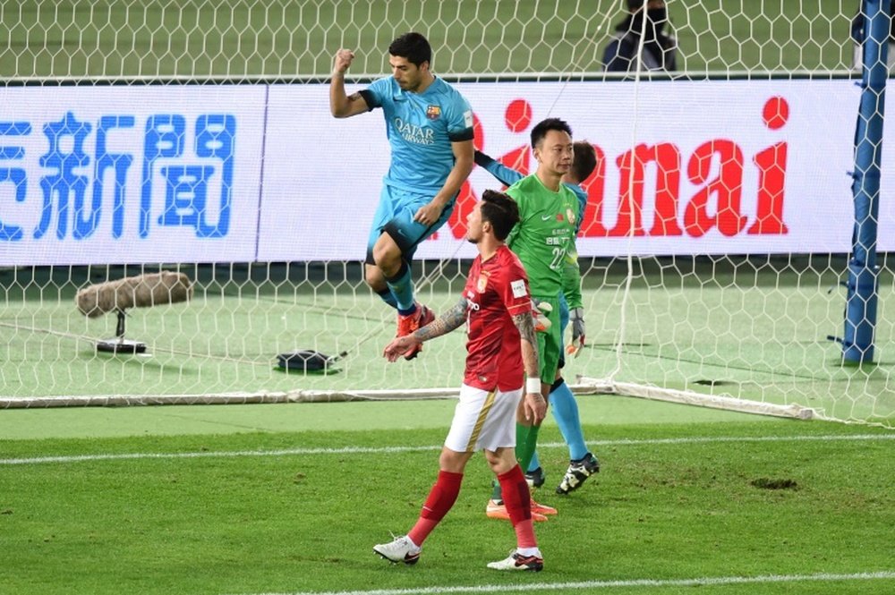 Luis Suarez celebrates one of his three goals against Guangzhou Evergrande