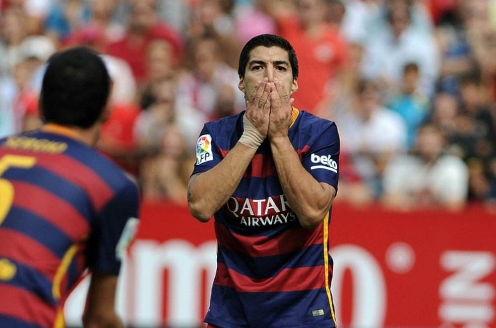 Barcelonas forward Luis Suarez (C) reacts during a Spanish league football match against Sevilla at the Ramon Sanchez Pizjuan stadium in Sevilla on October 3, 2015