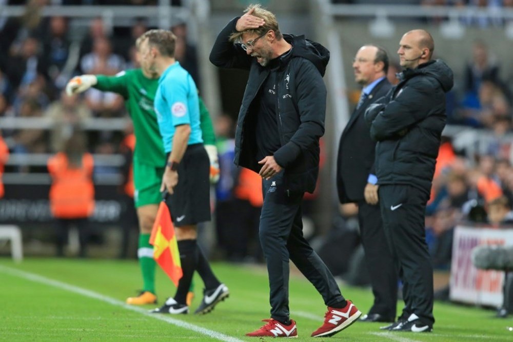 Klopp cut a frustrated figure in the dugout at St James' Park. AFP