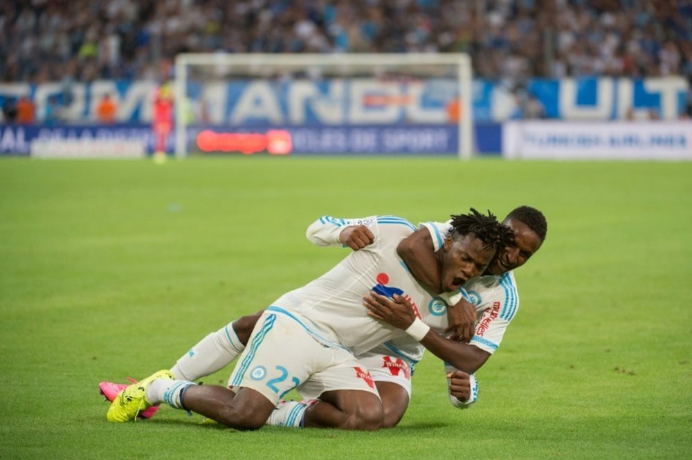 Marseilles Michy Batshuayi (L) is congratulated by Bouna Sarr after scoring a goal during the French L1 football match Olympique de Marseille vs Troyes on August 23, 2015 at the Velodrome stadium in Marseille, southern France