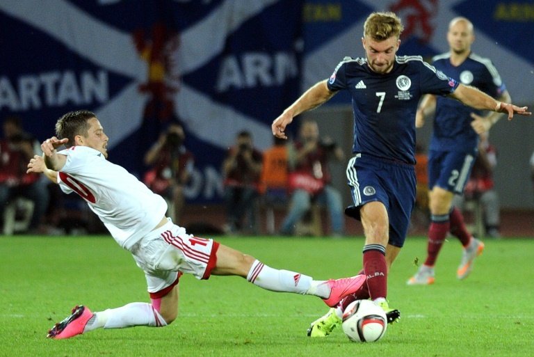 James Morrison (R) of Scotland vies for the ball with Jano Ananidze (L) of Georgia during their Euro 2016 qualifying football match in Tbilisi on September 4, 2015