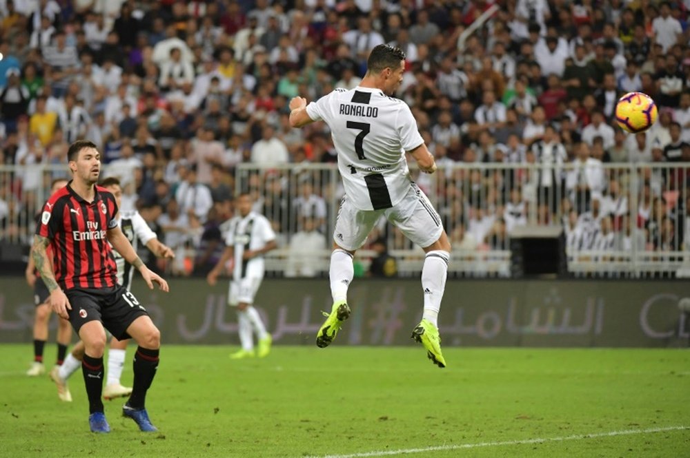 Cristiano Ronaldo rises to head home his 16th goal of the season. AFP