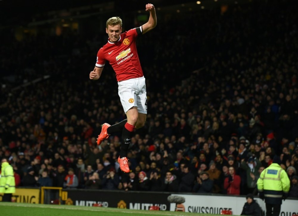 Manchester Uniteds English striker James Wilson celebrates scoring during the FA Cup fourth round replay football match between Manchester United and Cambridge United at Old Trafford in Manchester, England, on February 3, 2015