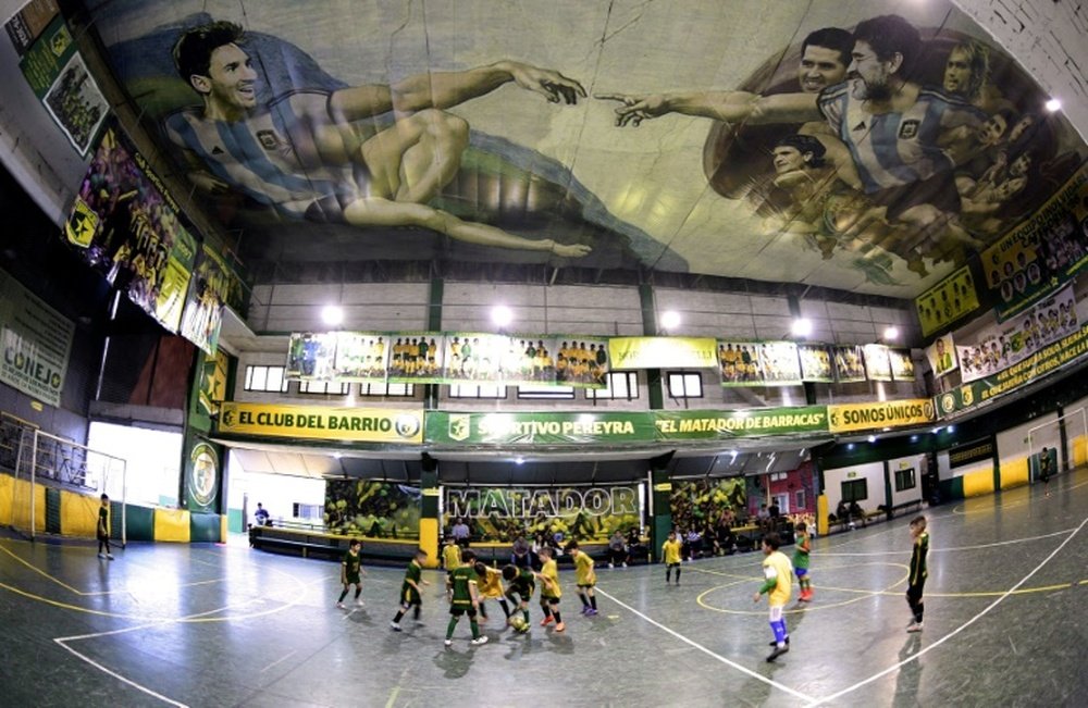 Sportivo Pereyra posses the strange mural. AFP
