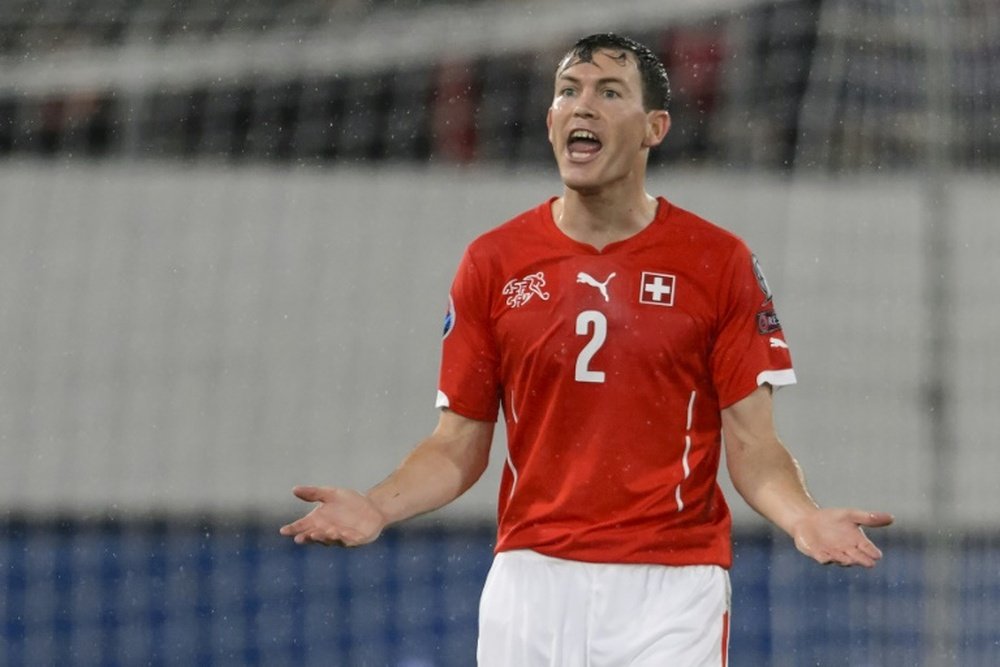 Lichtsteiner says his move to Arsenal is not yet complete. AFP