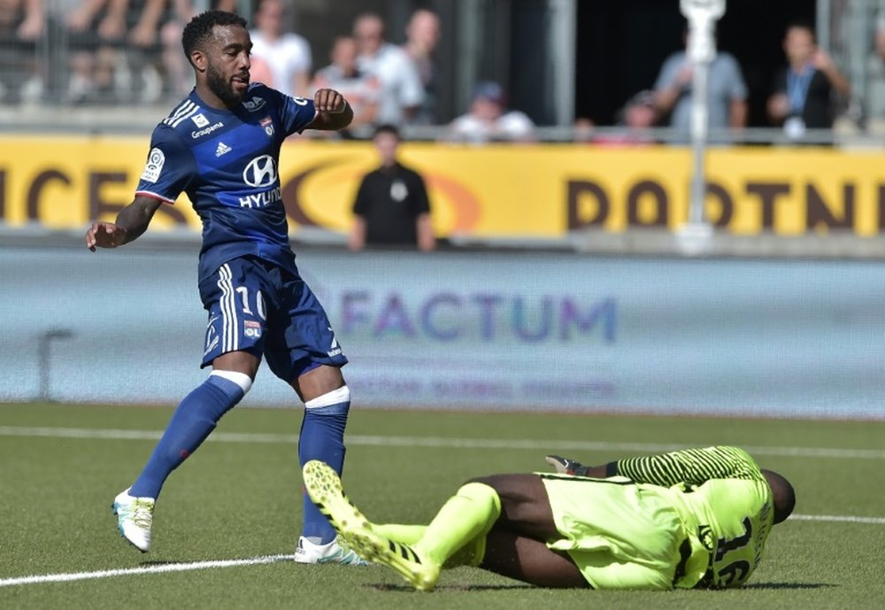 Alexandre Lacazette (L) scores for Lyon. AFP