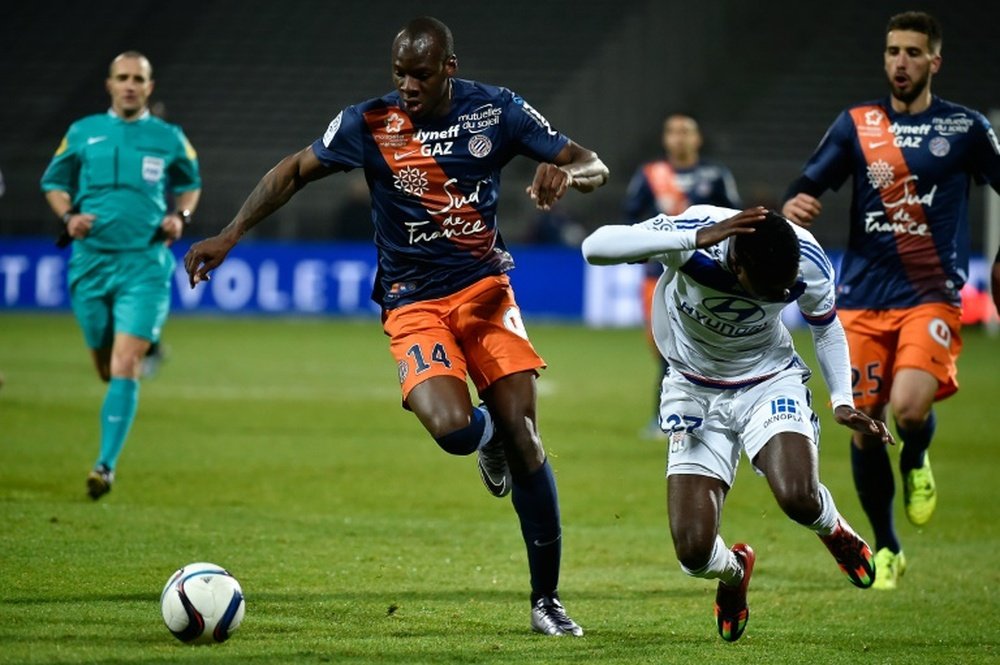 Montpelliers French midfielder Bryan Dabo (L) vies for the ball with Lyons French forward Maxwel Cornet (R) during the French L1 football match at the Gerland Stadium in Lyon, central-eastern France, on November 27, 2015