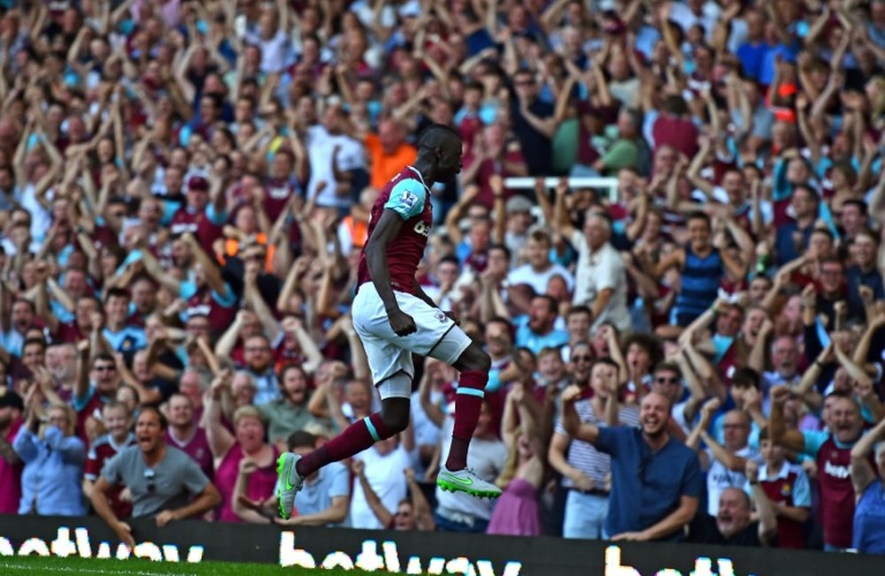 West Ham Uniteds Senegalese midfielder Cheikhou Kouyate celebrates in front of supporters during the English Premier League football match between West Ham United and Bournemouth in Upton Park, East London on August 22, 2015