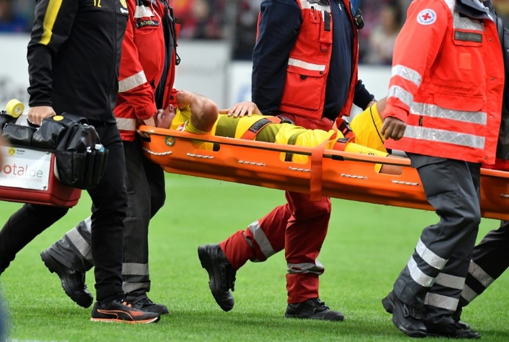 Marcel Schmelzer had to be carried off by stretcher during his side's match against Freiburg. AFP