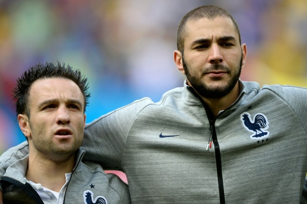 Mathieu Valbuena (left) and Karim Benzema listen to the French national anthem before the 2014 World Cup match against Nigeria in Brasilia on June 30, 2014