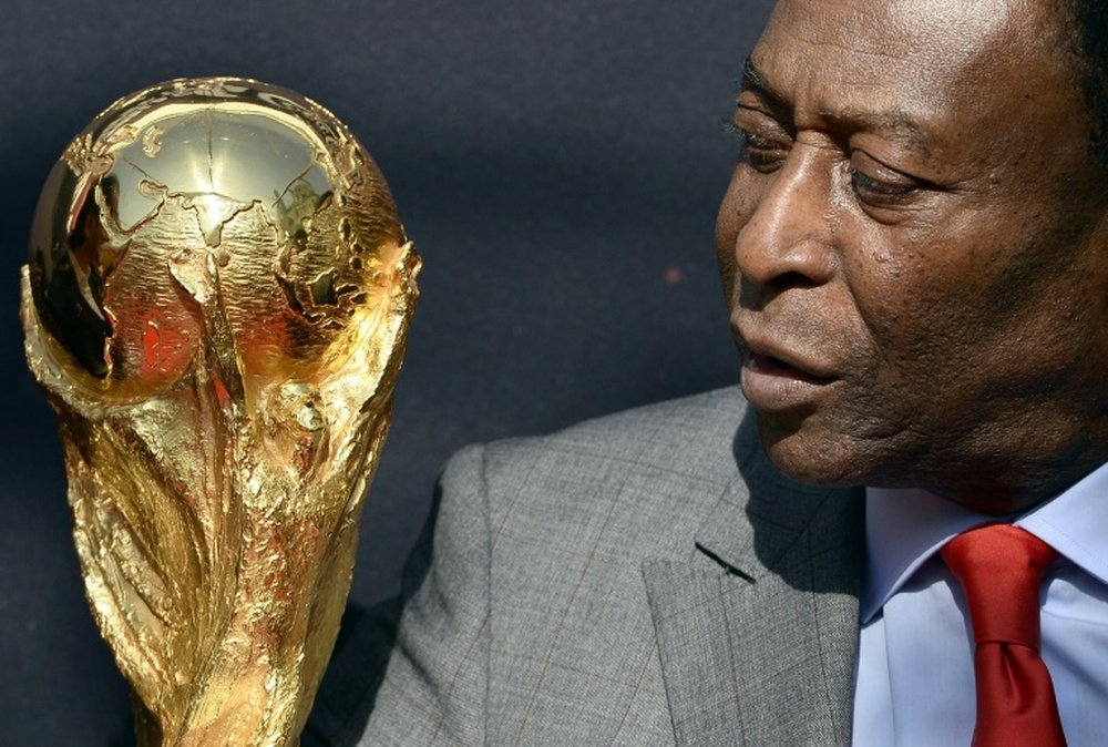 Brazilian legend Pele pictured with the World Cup trophy