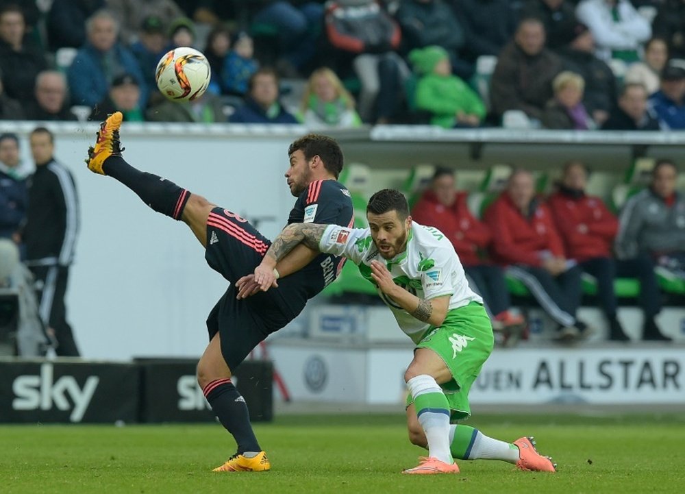 Bayern Munichs defender Juan Bernat (L) and Wolfsburgs striker Vieirinha vie for the ball during the German first division Bundesliga football match in Wolfsburg, northern Germany, on February 27, 2016