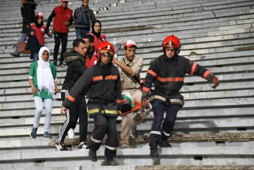 Emergency personnel carry an injured supporter at the Mohammed V Stadium in Casablanca. BeSoccer
