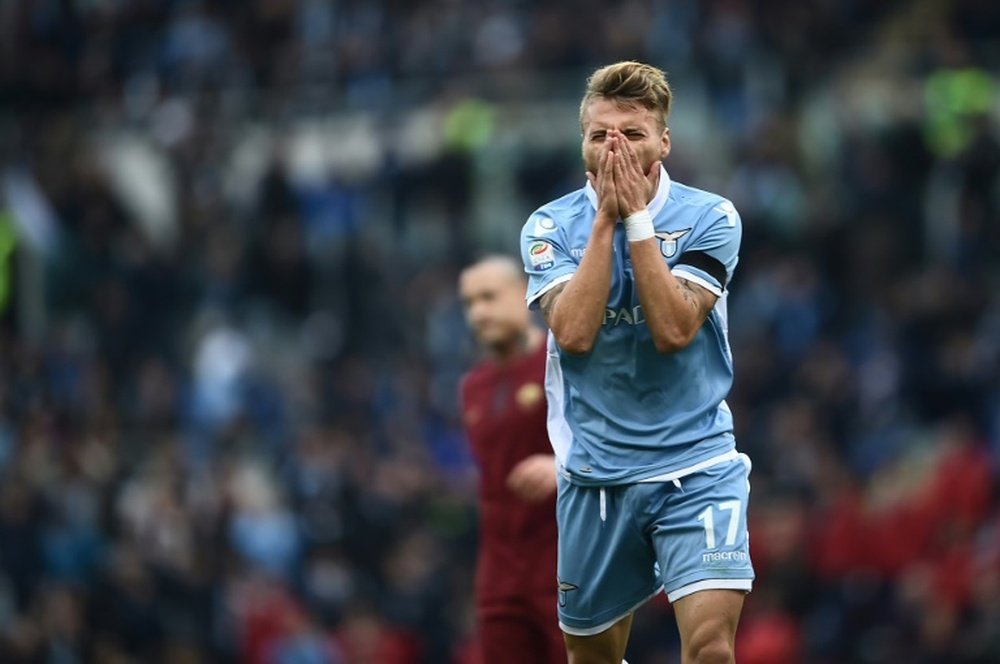 Lazios forward from Italy Ciro Immobile reacts during the Italian Serie A football match SS Lazio vs AS Roma on December 4, 2016