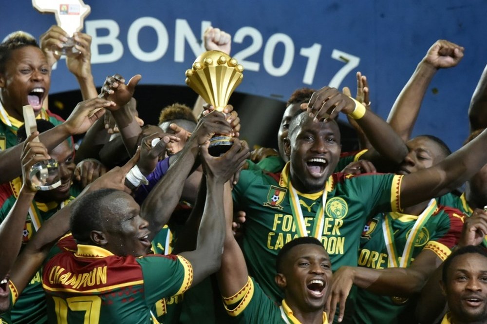 Cameroons players celebrate with the winners trophy
