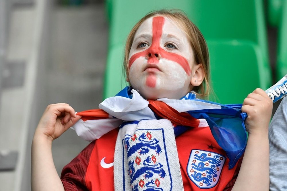 A young England supporter waits before the Euro 2016 group B football match between Slovakia and England at the Geoffroy-Guichard stadium in Saint-Etienne on June 20, 2016