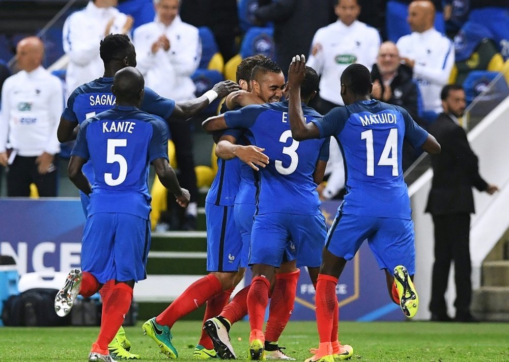 Frances forward Dimitri Payet (C) is congratuled by teammates after scoring a goal during the friendly football match between France and Cameroon, at the Beaujoire Stadium in Nantes, western France, on May 30, 2016