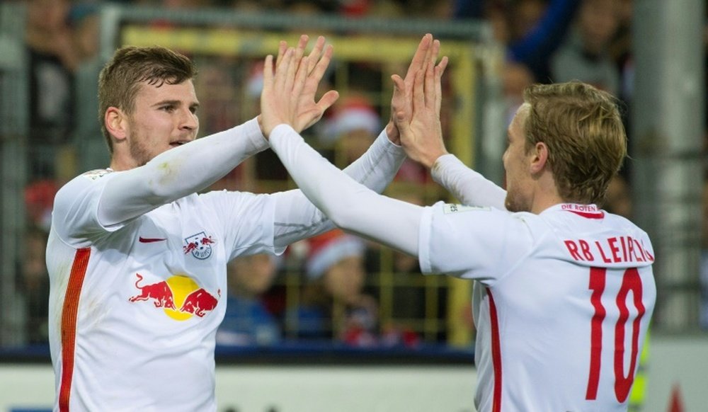 Leipzigs forward Timo Werner (L) celebrates with teammate forward Emil Forsberg after he scored during the German first division Bundesliga football match against SC Freiburg November 25, 2016