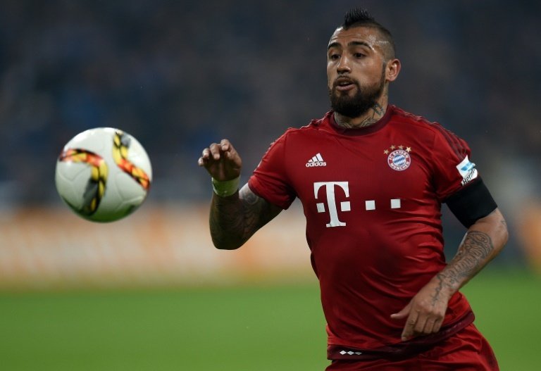 Bayern Munichs Chilean midfielder Arturo Vidal runs with the ball during a Bundesliga match against Schalke in Gelsenkirchen on November 21, 2015