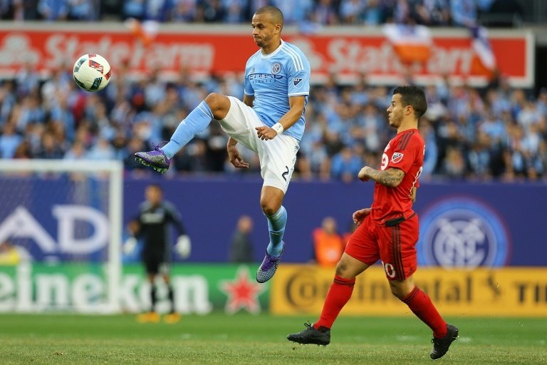 Jason Hernandez of New York City FC kicks the ball in front of Sebastian Giovinco of Toronto FC, at Yankee Stadium in New York, on March 13, 2016