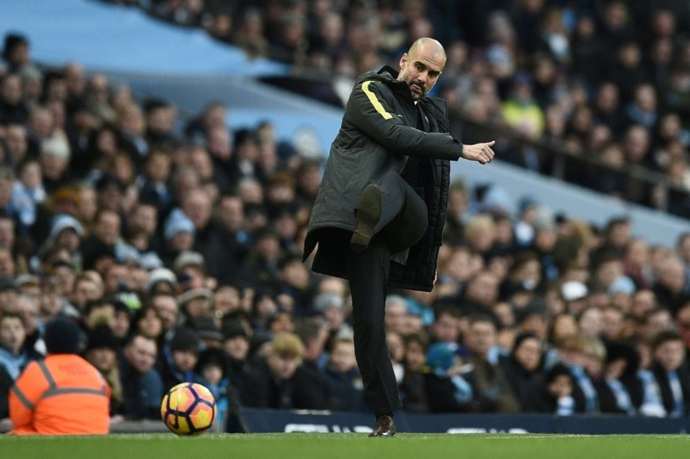 Pep Guardiola kicks the ball back onto the pitch during the match against Burnley. AFP