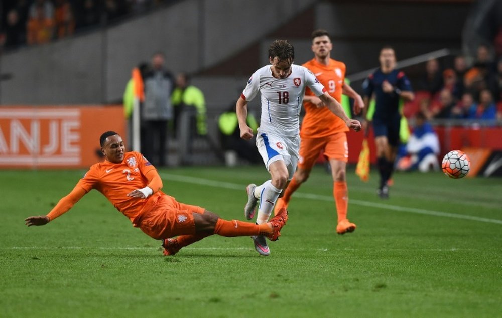 Czech Republics Josef Sural (R) is tackled by Netherlands Kenny Tete during the Euro 2016 qualifying football match at the Amsterdam Arena in Amsterdam, October 13, 2015