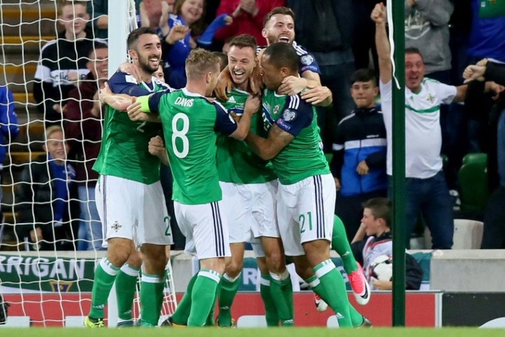 Northern Ireland's defender Jonny Evans (C) celebrates scoring during a World Cup qualifier. AFP